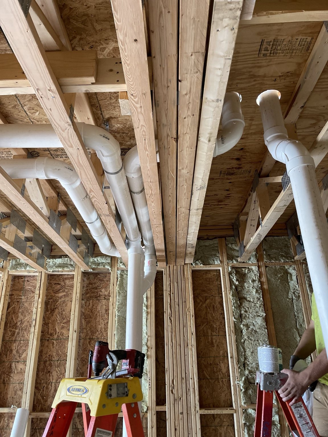 A-1 overhead drain piping installed between floor joists