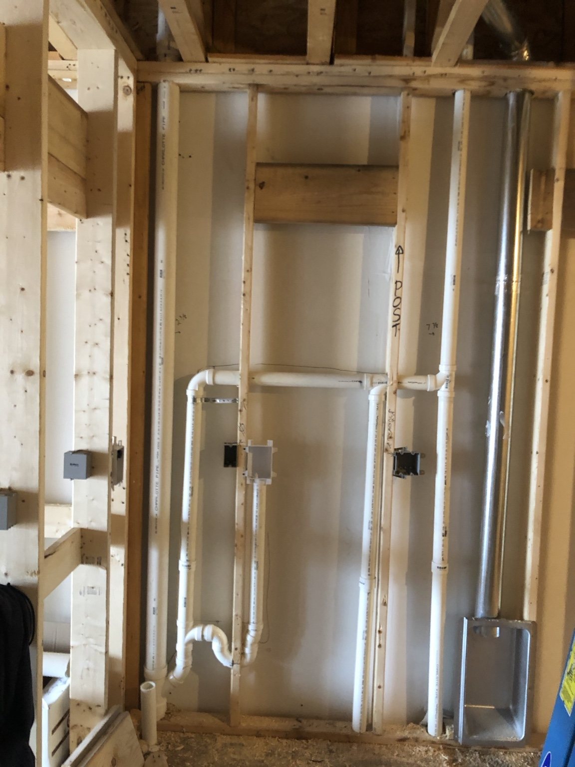 A-1 plumbing rough-in with drain and vent piping inside wall framing